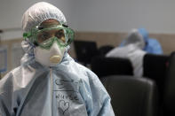 A nurse wears protective gear in a ward dedicated for people infected with the new coronavirus, at a hospital in Tehran, Iran, Sunday, March 8, 2020. With the approaching Persian New Year, known as Nowruz, officials kept up pressure on people not to travel and to stay home. Health Ministry spokesman Kianoush Jahanpour, who gave Iran's new casualty figures Sunday, reiterated that people should not even attend funerals. (AP Photo/Mohammad Ghadamali)