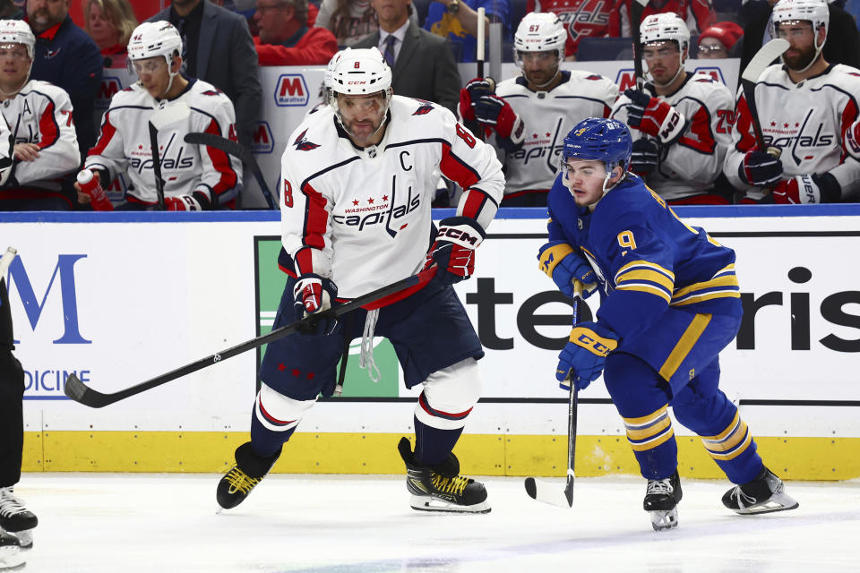Washington Capitals left wing Alex Ovechkin (8) and Buffalo Sabres left wing Zach Benson (9) work for position during the second period of an NHL hockey game Thursday, April 11, 2024, in Buffalo, N.Y. (AP Photo/Jeffrey T. Barnes)