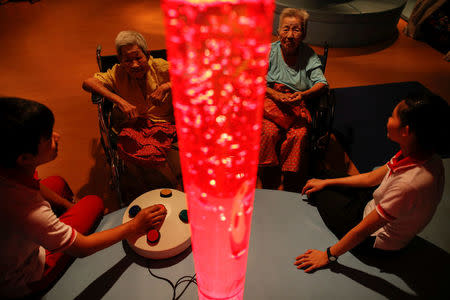 Elderly people attend a physical therapy session at Bangkhae Home Foundation in Bangkok, Thailand, April 27, 2016. REUTERS/Athit Perawongmetha