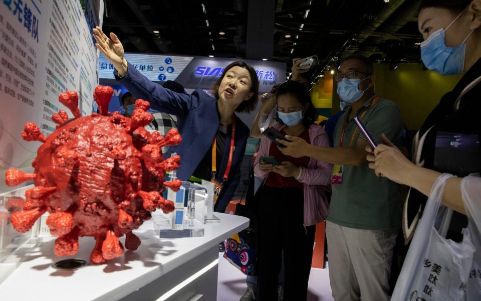 Samples of a Covid-19 vaccine produced by Sinopharm subsidiary CNBG are displayed during a trade fair in Beijing  - AP