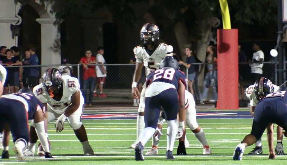 Central High quarterback Earl Riley takes a snap against San Joaquin Memorial on Friday, Aug. 25, 2023.