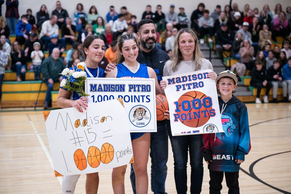 The Pitro family, from left, Emily, Maddie, John, Danielle and Tommy pose for photo after Maddie scored her 1,000th point Friday during the Clinton Holiday Tournament.