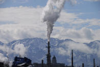 The Utah State Capitol, rear, is shown behind an oil refinery on Thursday, May 12, 2022, in Salt Lake City. A growing number of Republican-led states with economies that rely heavily on fossil fuels are pushing back against shifts in the financial industry to consider new factors such as environmental risk in their investment decisions. (AP Photo/Rick Bowmer)