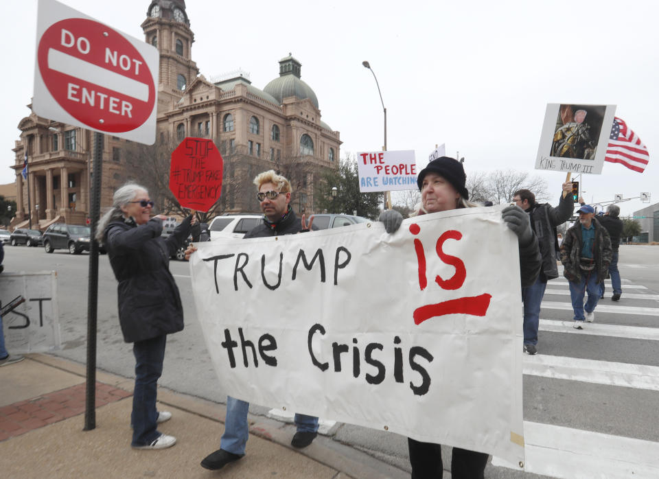 Carolyn Hursh, right, and Joey Daniel, carry a sign during a protest with others in downtown Fort Worth, Texas, Monday, Feb. 18, 2019. (AP Photo/LM Otero)