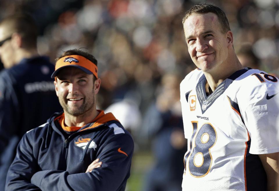 Denver Broncos quarterback Peyton Manning (18) stands on the sideline with wide receiver Wes Welker during the second half of an NFL football game against the Oakland Raiders, Sunday, Dec. 29, 2013, in Oakland, Calif. (AP Photo/Marcio Jose Sanchez)