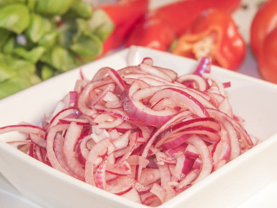 pickled red onion in a white bowl