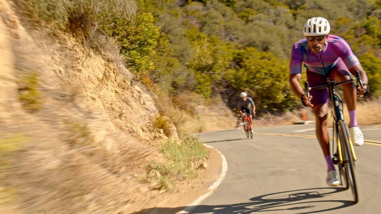 black male cyclist leading peloton on a bike ride