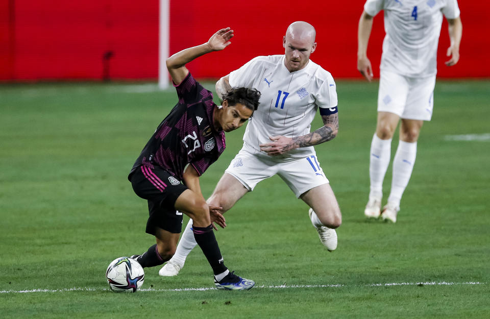 Diego Lainez, delantero de México, trata de eludir a Aaron Einar Gunnarson, de Islandia, en un partido amistoso disputado el sábado 29 de mayo de 2021 en Arlington, Texas (AP Foto/Brandon Wade)