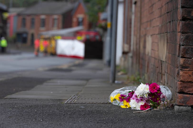 Floral tributes have been left for the man who died following the crash -Credit:Manchester Evening News