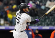 Colorado Rockies' C.J. Cron watches his three-run home run off Houston Astros relief pitcher Joe Smith during the eighth inning of a baseball game Tuesday, April 20, 2021, in Denver. (AP Photo/David Zalubowski)