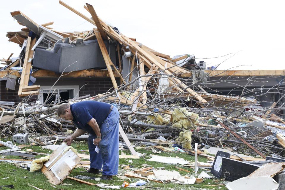 Terry Kicking sifts through the damage after a tornado leveled his home, Friday, April 26, 2024, in Omaha, Neb. (Nikos Frazier/Omaha World-Herald via AP)