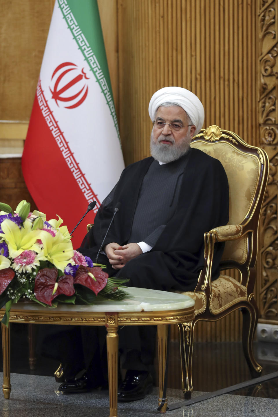 In this photo released by the official website of the office of the Iranian Presidency, President Hassan Rouhani briefs media at Mehrabad airport pavilion upon arriving in Tehran from New York, where he attended the United Nations General Assembly, Iran, Friday, Sept. 27, 2019. Rouhani said U.S. sanctions on his country are "more unstable than ever." (Iranian Presidency Office via AP)