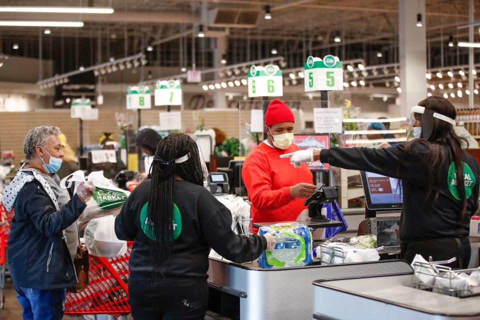 A customer pays for his groceries after shopping at the Local Market Foods store in Chicago, Illinois, on April 8, 2020. (Photo by KAMIL KRZACZYNSKI / AFP) (Photo by KAMIL KRZACZYNSKI/AFP via Getty Images)