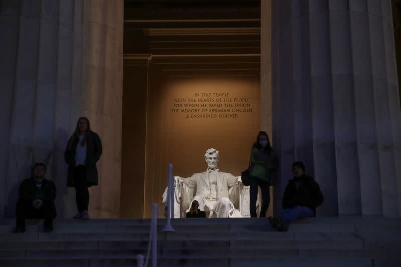 A few people take to the steps at the Lincoln Memorial during the coronavirus disease (COVID-19) outbreak, where normally thousands of Christians would gather for worship at Easter sunrise, in Washington