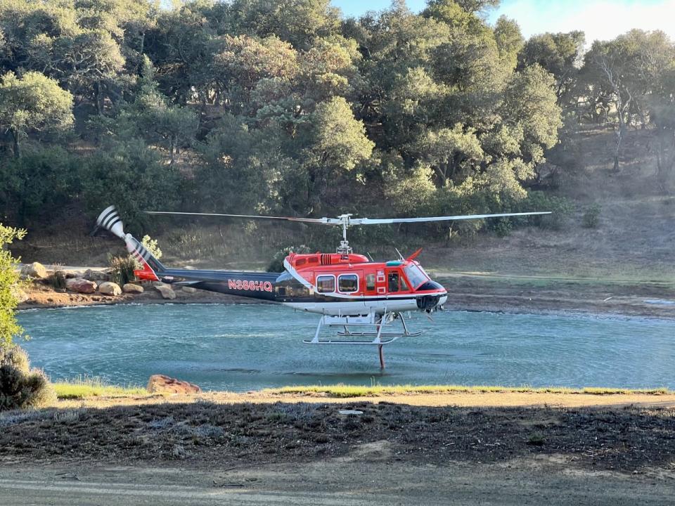 A helicopter snorkels up water on the Reagan Ranch - Credit: Andrew Coffin/YAF