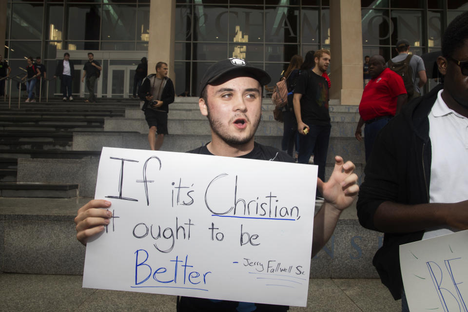 Junior Jonah Lackey converses with other students during a student protest on Friday, Sept. 13, 2019, at Liberty University in Lynchburg, Va. Students at Liberty University gathered to protest in the wake of news articles alleging that school president Jerry Falwell Jr. "presides over a culture of self-dealing” and improperly benefited from the institution. Falwell Jr. told The Associated Press on Tuesday that he wants the FBI to investigate what he called a "criminal" smear campaign orchestrated against him by several disgruntled former board members and employees.(Emily Elconin/The News & Advance via AP)