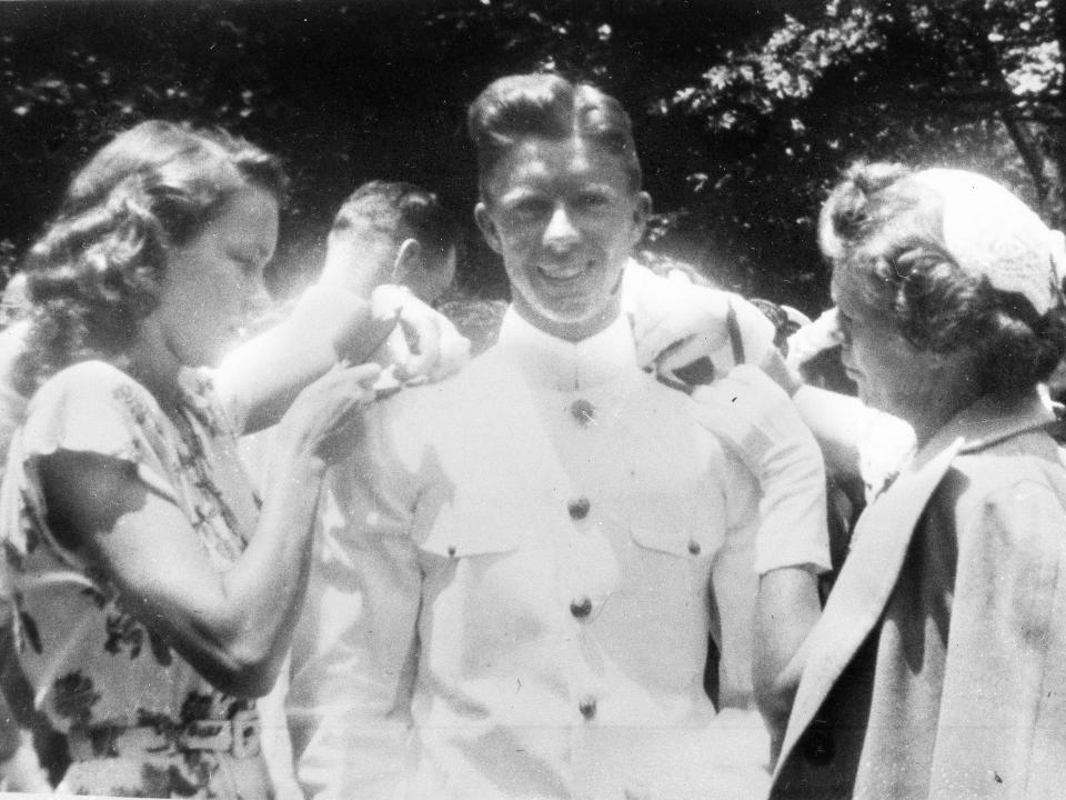 Jimmy Carter gets his bars pinned on by his wife Rosalynn, left and his mother, Mrs. Lillian Carter at the U.S. Naval Academy in this undated photo.