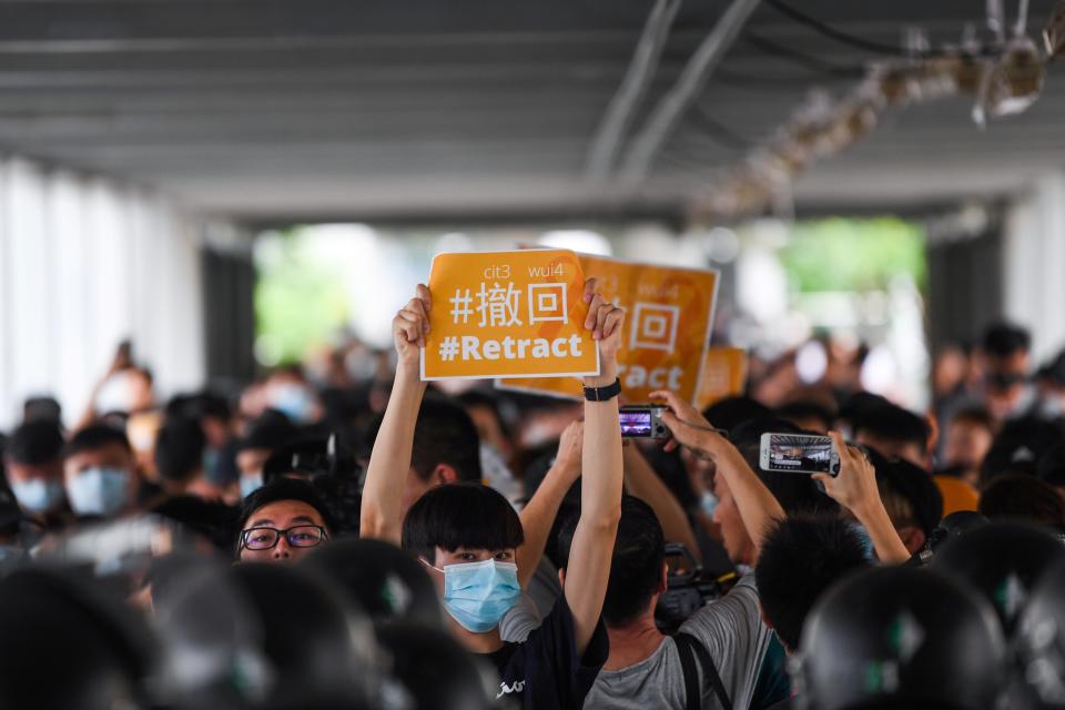 TOPSHOT - Protesters display placards during a demonstration against a controversial extradition law proposal in Hong Kong on June 13, 2019. - Asian markets fell again on June 13 with Hong Kong suffering a second straight day of heavy losses as investors fret over the impact of protests in the city and plans to introduce a controversial law allowing extradition to China. (Photo by Anthony WALLACE / AFP)        (Photo credit should read ANTHONY WALLACE/AFP/Getty Images)