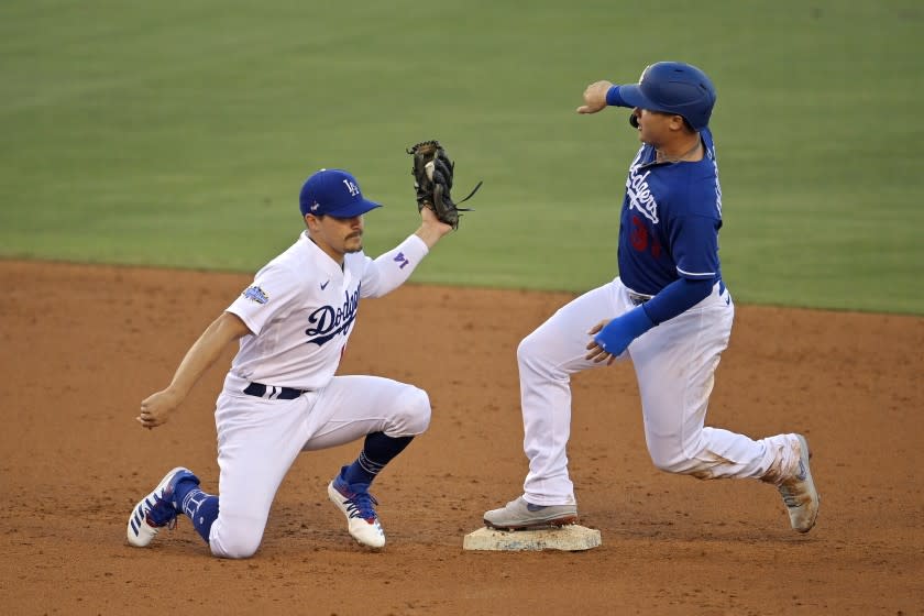 Los Angeles Dodgers' Joc Pederson, right, is safe at second on a steal after Enrique Hernandez put a late tag on him during an intrasquad baseball game Thursday, July 9, 2020, in Los Angeles. (AP Photo/Mark J. Terrill)