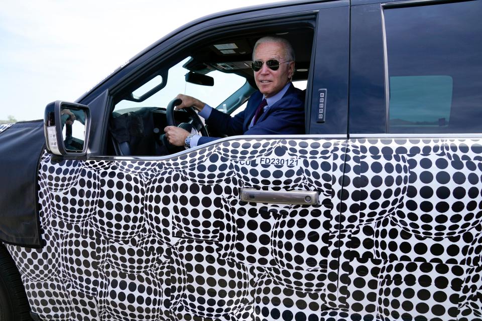 Joe Biden stops to talk to the media as he drives a Ford F-150 Lightning  (AP)