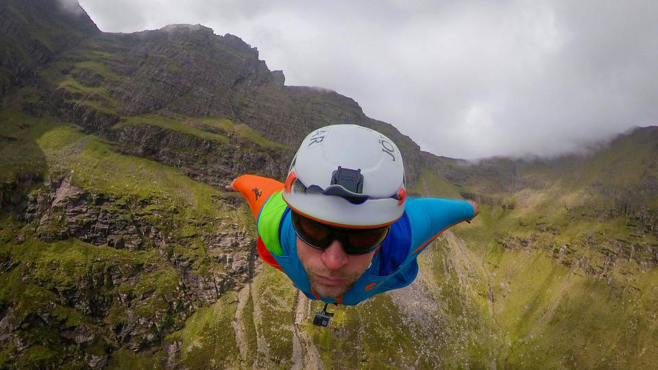 A brave base jumper has become the first person ever to fly a wingsuit from the top of a British mountain. Former Royal Marine Tim Howell, 31, leapt from the 4,000ft peak of An Teallach in the northwest Highlands in Scotland. He plunged down a steep gully for 30 seconds before deploying his parachute and landing safely on the banks of Loch Toll an Lochain.