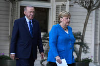 German Chancellor Angela Merkel, right, and Turkish President Recep Tayyip Erdogan arrive for a joint news conference following their meeting at Huber Villa presidential palace, in Istanbul, Turkey, Saturday, Oct. 16, 2021. The leaders discussed Ankara's relationship with Germany and the European Union as well as regional issues including Syria and Afghanistan. (AP Photo/Francisco Seco)