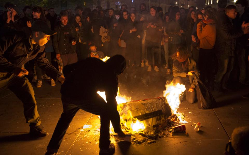 People burn litter as they protest in Paris - Credit: AP