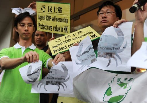 Members of the Democratic Party tear up images of the front page of the South China Morning Post (SCMP) newspaper, positioned under an image of a river crab, during a protest in Hong Kong, on June 21. The protest was organised after the group claimed that the editor-in-chief of the paper censored a breaking story on the recent death of dissident Li Wangyang in China