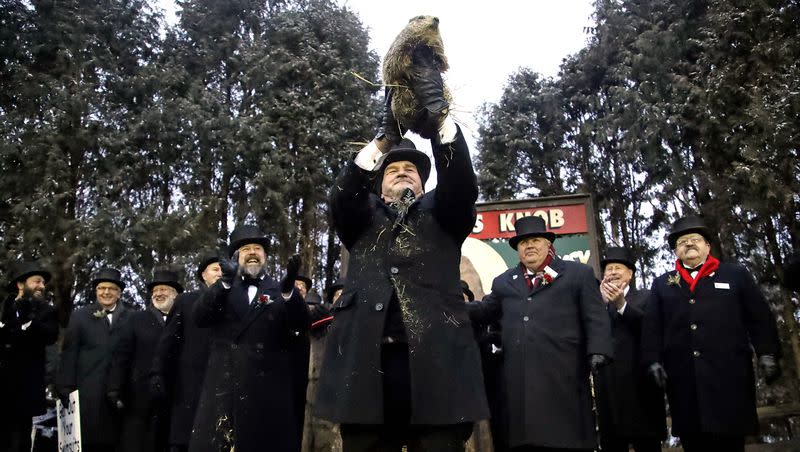 Groundhog Club co-handler John Griffiths, center, holds Punxsutawney Phil, the weather prognosticating groundhog, during the 133rd celebration of Groundhog Day on Gobbler’s Knob in Punxsutawney, Pa., on Feb. 2, 2019.