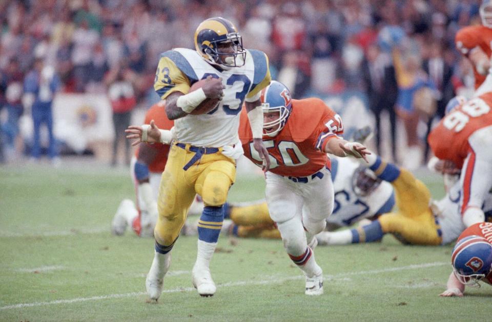 Rams running back Charles White runs with the ball against the Denver Broncos on Aug. 9, 1987.