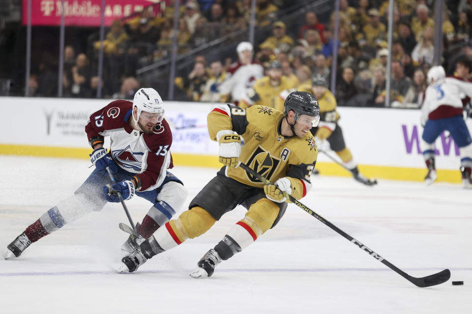 Vegas Golden Knights defenseman Brayden McNabb (3) skates past Colorado Avalanche right wing Valeri Nichushkin (13) during the first period of an NHL hockey game Sunday, April 14, 2024, in Las Vegas. (AP Photo/Ian Maule)