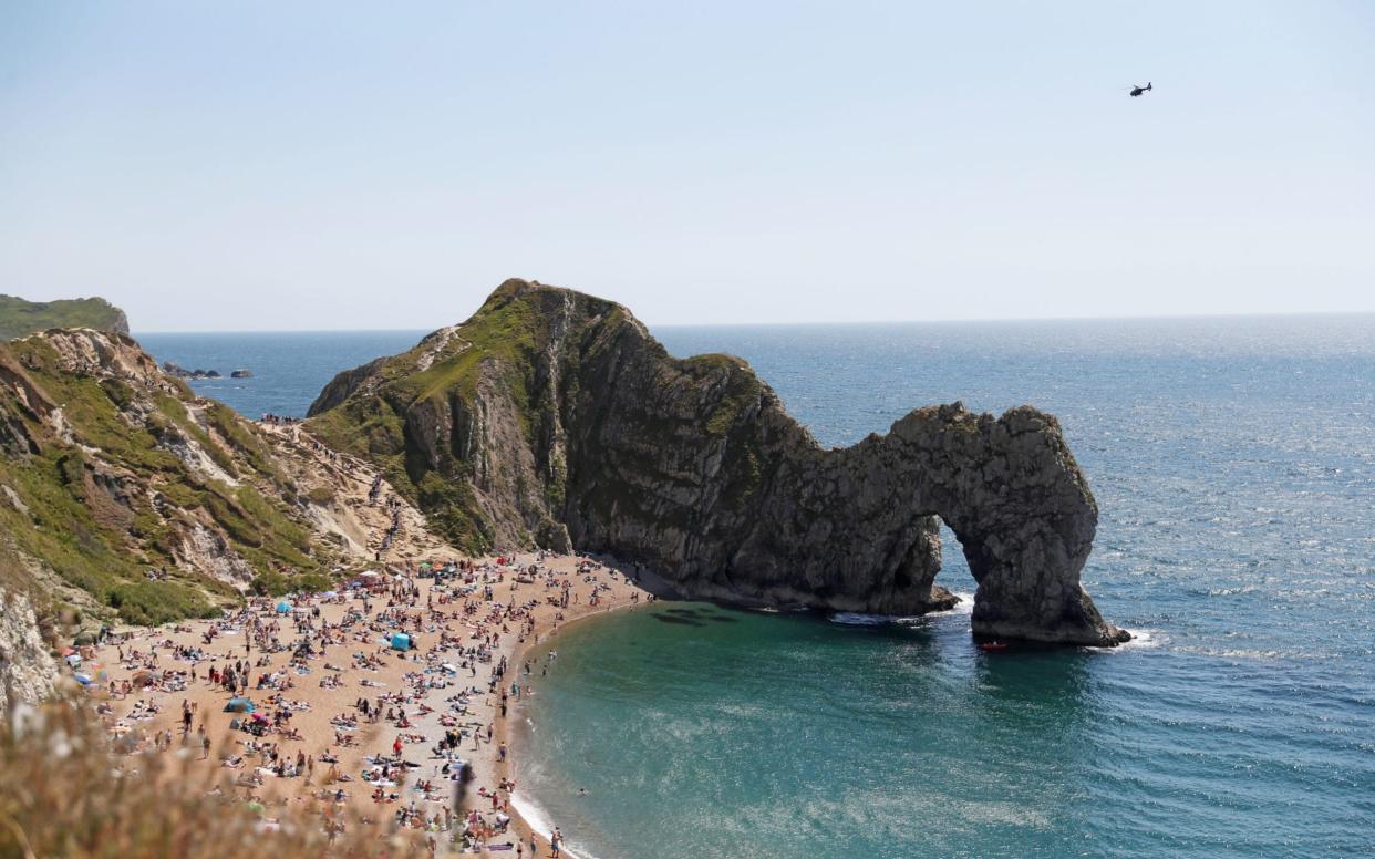 Tourists ignored road closed signs to enjoy the Dorset beach - PA