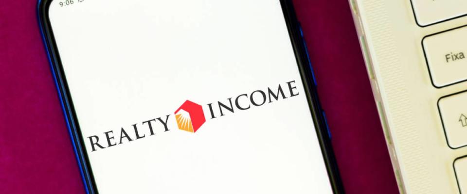 Realty Income Corporation logo seen displayed on a smartphone.