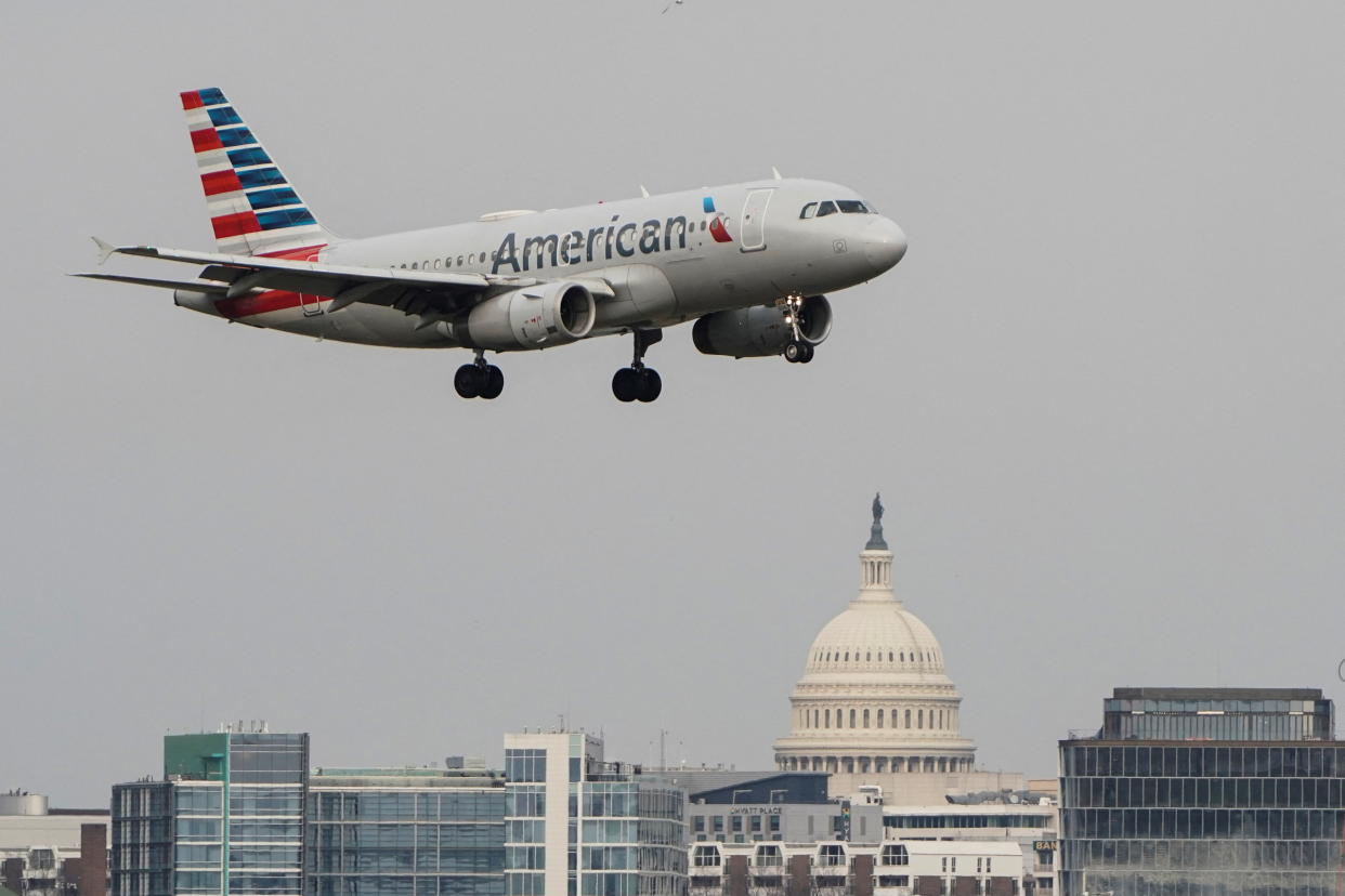 An American Airlines aircraft flies past the U.S. Capitol before landing at Reagan National Airport in Arlington, Virginia, U.S., January 24, 2022.   REUTERS/Joshua Roberts