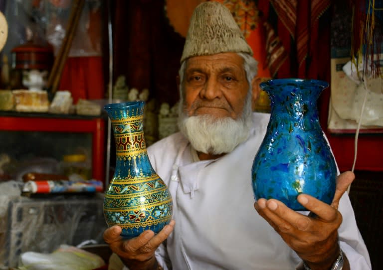 Sultan Ahmad Hamidi sells Herati glassware at his handicraft shop in Herat province