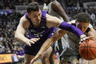 Northwestern forward Robbie Beran (31) reaches for a loose ball with Purdue forward Mason Gillis (0) in the first half of an NCAA college basketball game in West Lafayette, Ind., Sunday, Jan. 23, 2022. (AP Photo/AJ Mast)