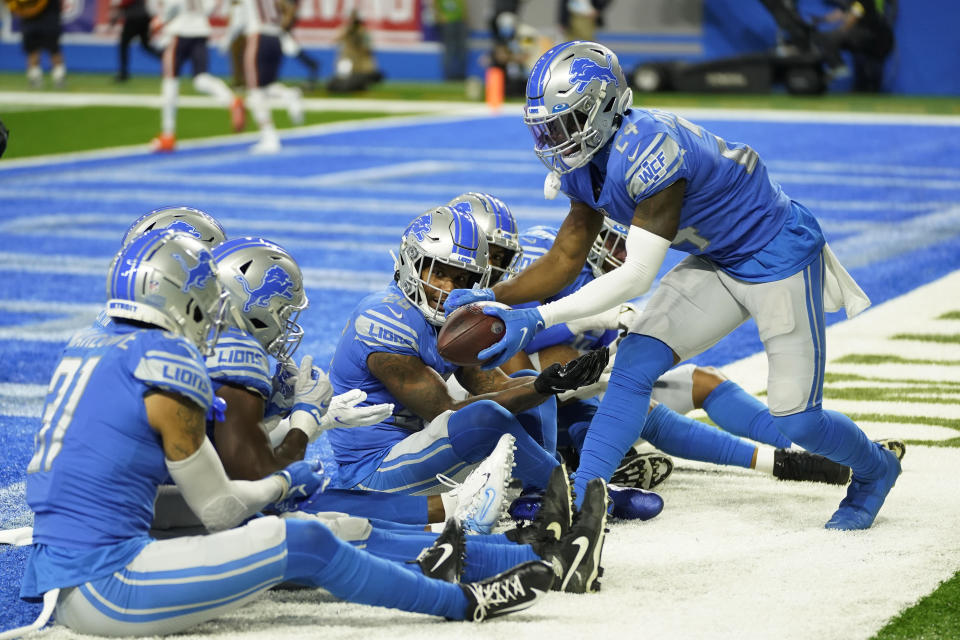 Detroit Lions cornerback Amani Oruwariye, right, celebrates his interception with teammates during the first half of an NFL football game against the Chicago Bears, Thursday, Nov. 25, 2021, in Detroit. (AP Photo/Paul Sancya)