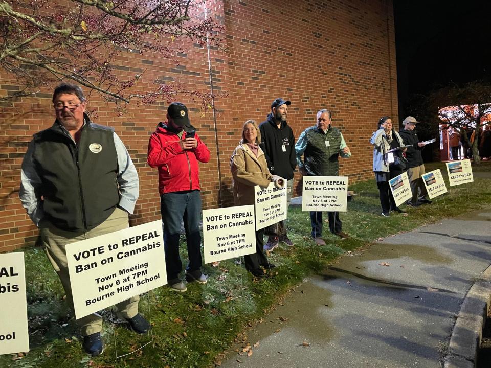 Proponents and opponents of a ban repeal on cannabis sales line up by the Bourne High School entrance before a special town meeting Monday night. On the fifth try, voters agreed to allow the sale of recreational marijuana in town.