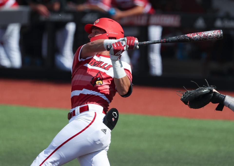 U of L's Ben Metzinger (22) hits a two-run homerun against Michigan during NCAA Regional play at Jim Patterson Stadium in Louisville, Ky. on June 5, 2022.
