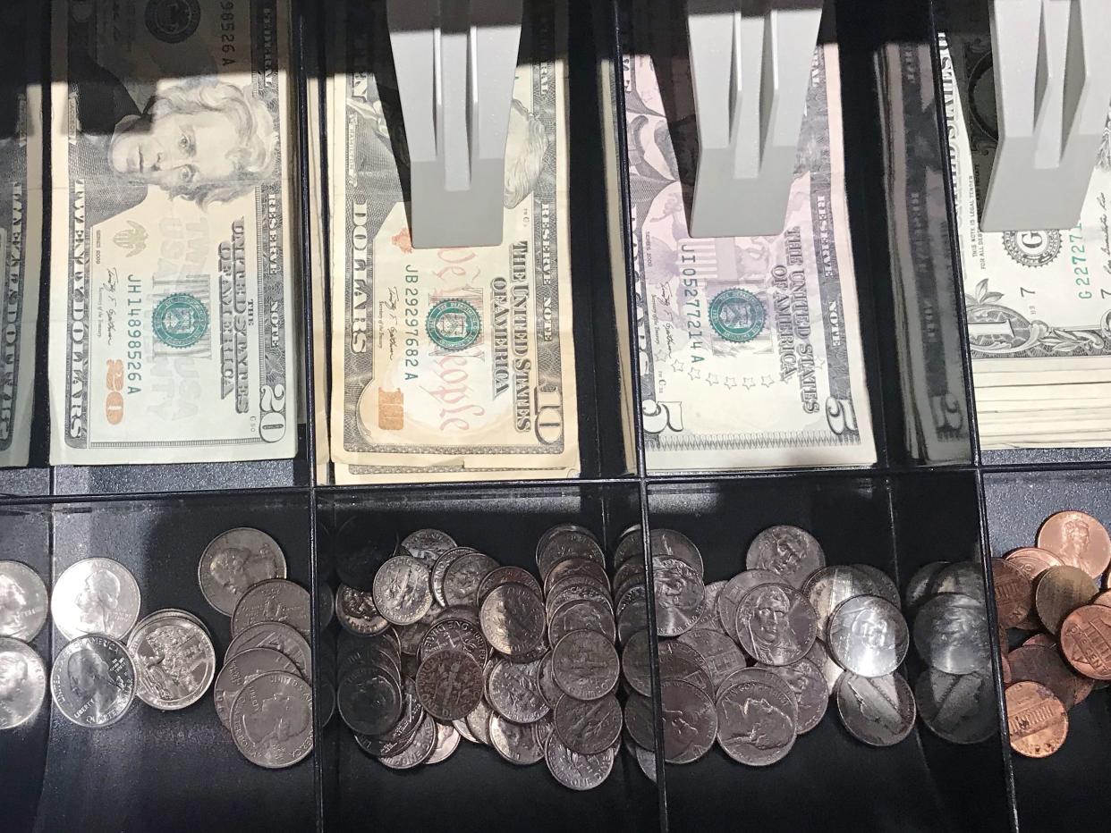 cash register filled with money- bills cropped at 80%