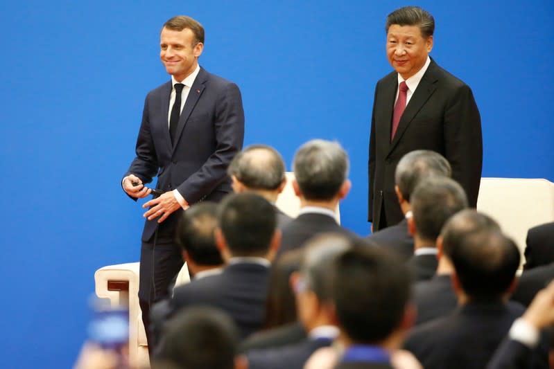 French President Emmanuel Macron and Chinese President Xi Jinping attend a China-France Economic Forum at the Great Hall of the People in Beijing