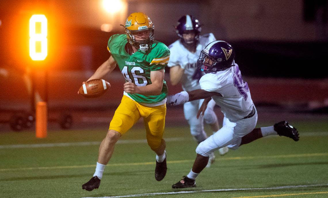 In the safety-saving play of the game, Tumwater punter Xavier Ickert carries a muffed snap punt out of the back of the end zone in front of North Kitsap defensive back Morgan Paul during Friday night’s 2A football game at Tumwater District Stadium in Tumwater, Washington, on Sept. 9, 2022. Tumwater won the game, 8-6.