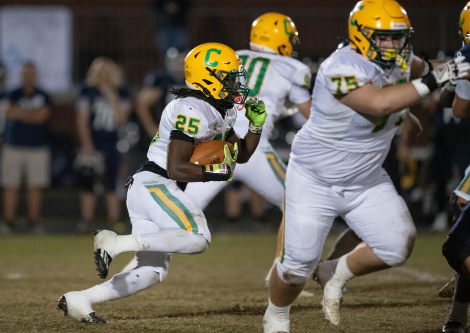 C.J. Nettles (25) carries the ball during the Catholic vs Walton high school playoff football game at Walton HIgh School in DeFuniak Springs on Friday, Nov. 17, 2023.