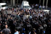 FILE PHOTO: Pro-Kurdish HDP lawmakers are surrounded by riot police as they protest against detention of their local politicians in Diyarbakir