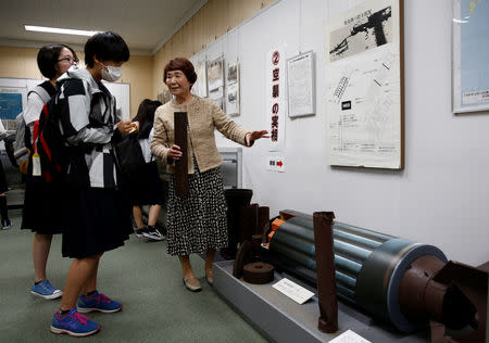 Haruyo Nihei explains to the school girls visiting a museum about the March 10, 1945 U.S. firebombing in Tokyo, Japan April 19, 2019. REUTERS/Kim Kyung-hoon