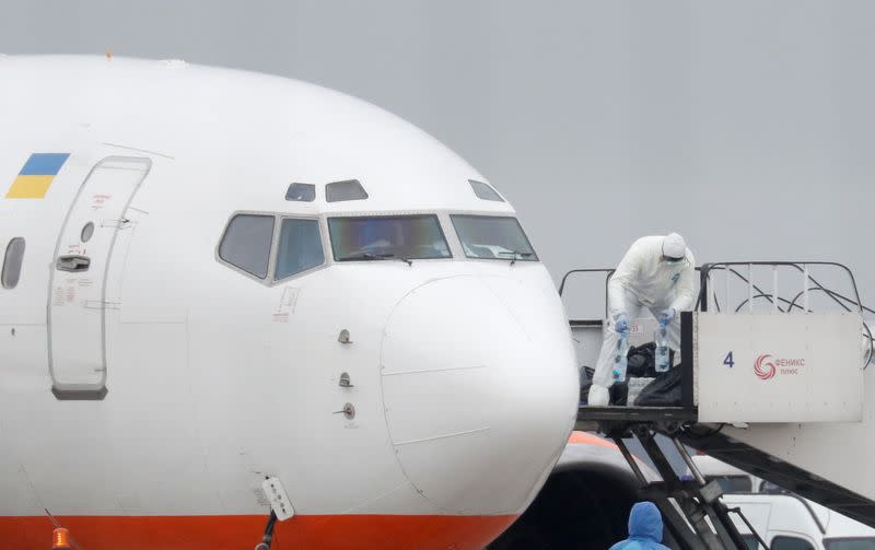 An aircraft transporting passengers from China is seen at an airport outside Kiev