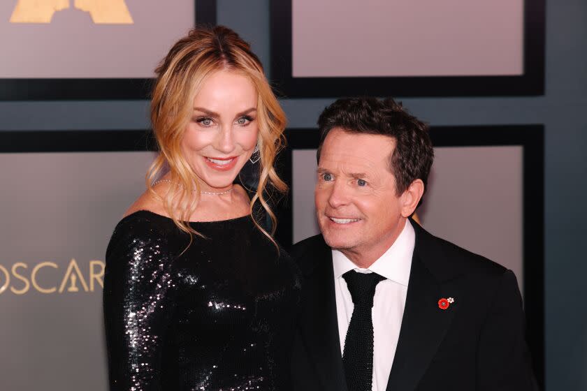 Tracy Pollan and Michael J. Fox walk the red carpet at the Academy of Motion Picture Arts and Sciences Governors Awards.