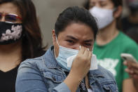 An employee of ABS-CBN wipes her tears after hearing the results of the voting at the House of Representative for the franchise renewal of her company in Quezon City, Philippines, Friday, July 10, 2020. Philippine lawmakers voted Friday to reject the license renewal of the country's largest TV network ABS-CBN, shutting down a major news provider that had been repeatedly threatened by the president over its critical coverage. (AP Photo/Aaron Favila)