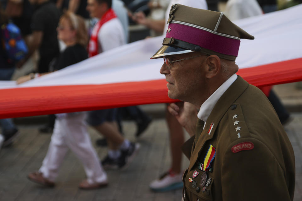 Supporters of the far-right organization National-Radical Camp, ONR, take part in the commemoration of the 1944 Warsaw Uprising, in Warsaw, Poland, Monday Aug. 1, 2022. Poles are marking the 78th anniversary of the Warsaw Uprising, a doomed revolt against Nazi German forces during World War II. (AP Photo/Michal Dyjuk)