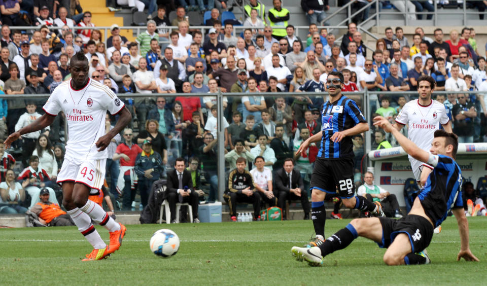 Atalanta's Giampaolo Bellini, right, scores an own goal during a Serie A soccer match against AC Milan in Bergamo, Italy, Sunday, May 11, 2014. (AP Photo/Felice Calabro')